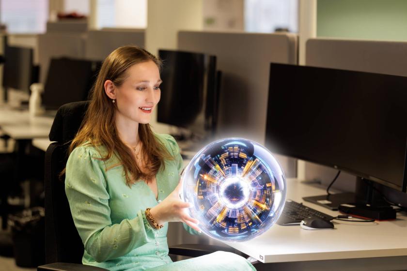 Sara Kinnunen käsissään tekoälyn avulla tehty kristallipallo.