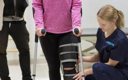 Sairaanhoitaja kuntouttaa potilasta.